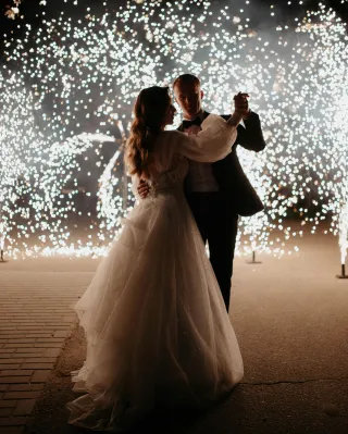 Bride and groom dancing with twinkling lights