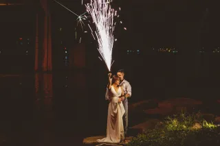 Bride with sparkler fireworks at evening wedding