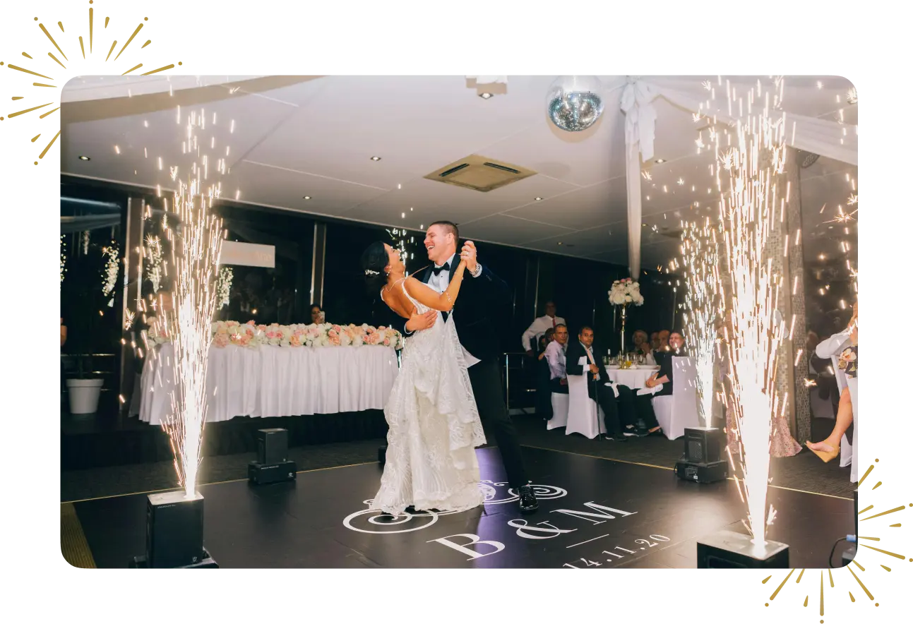 A couple is dancing in front of the bride and groom.